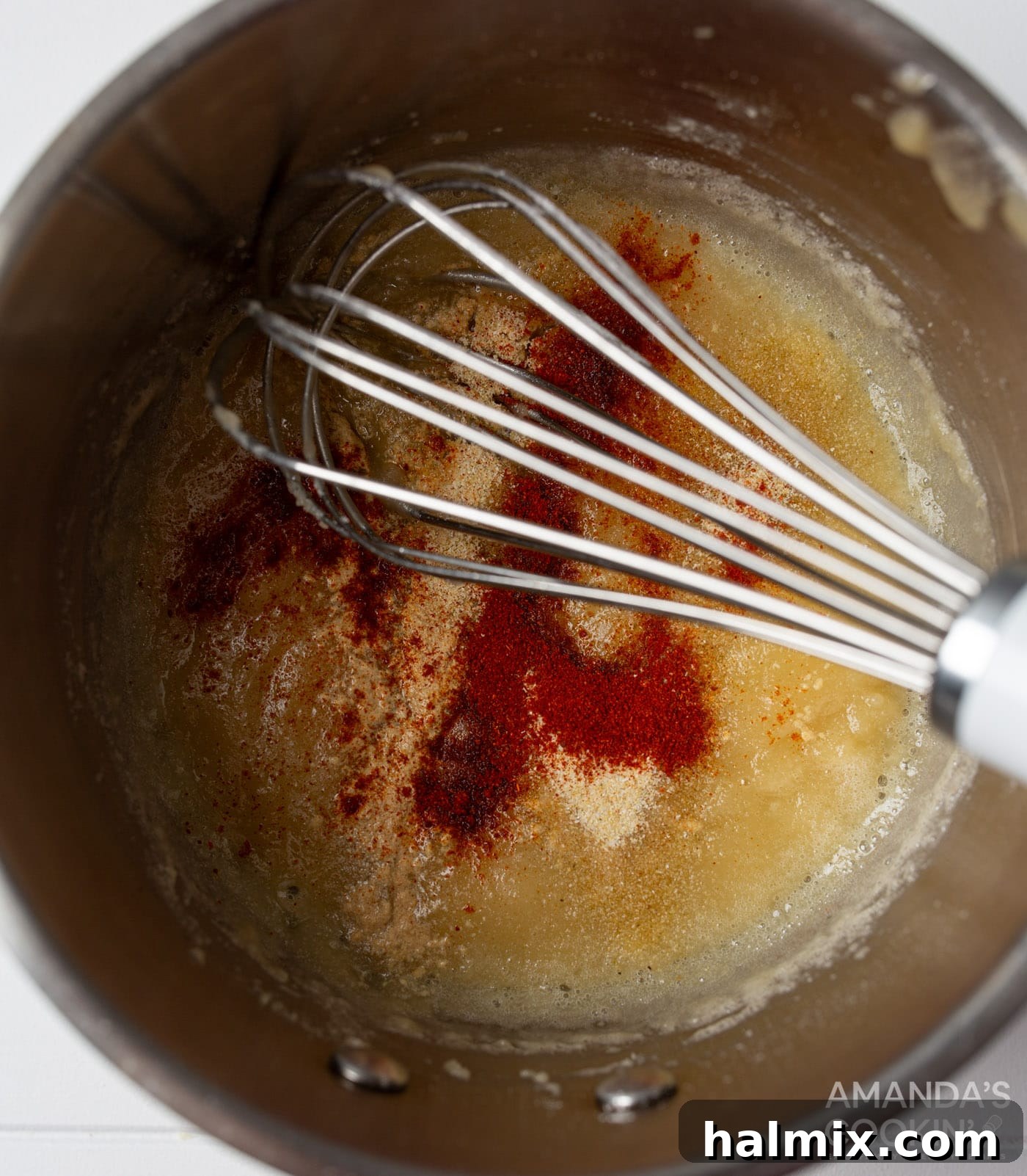 whisking spices into butter and flour roux