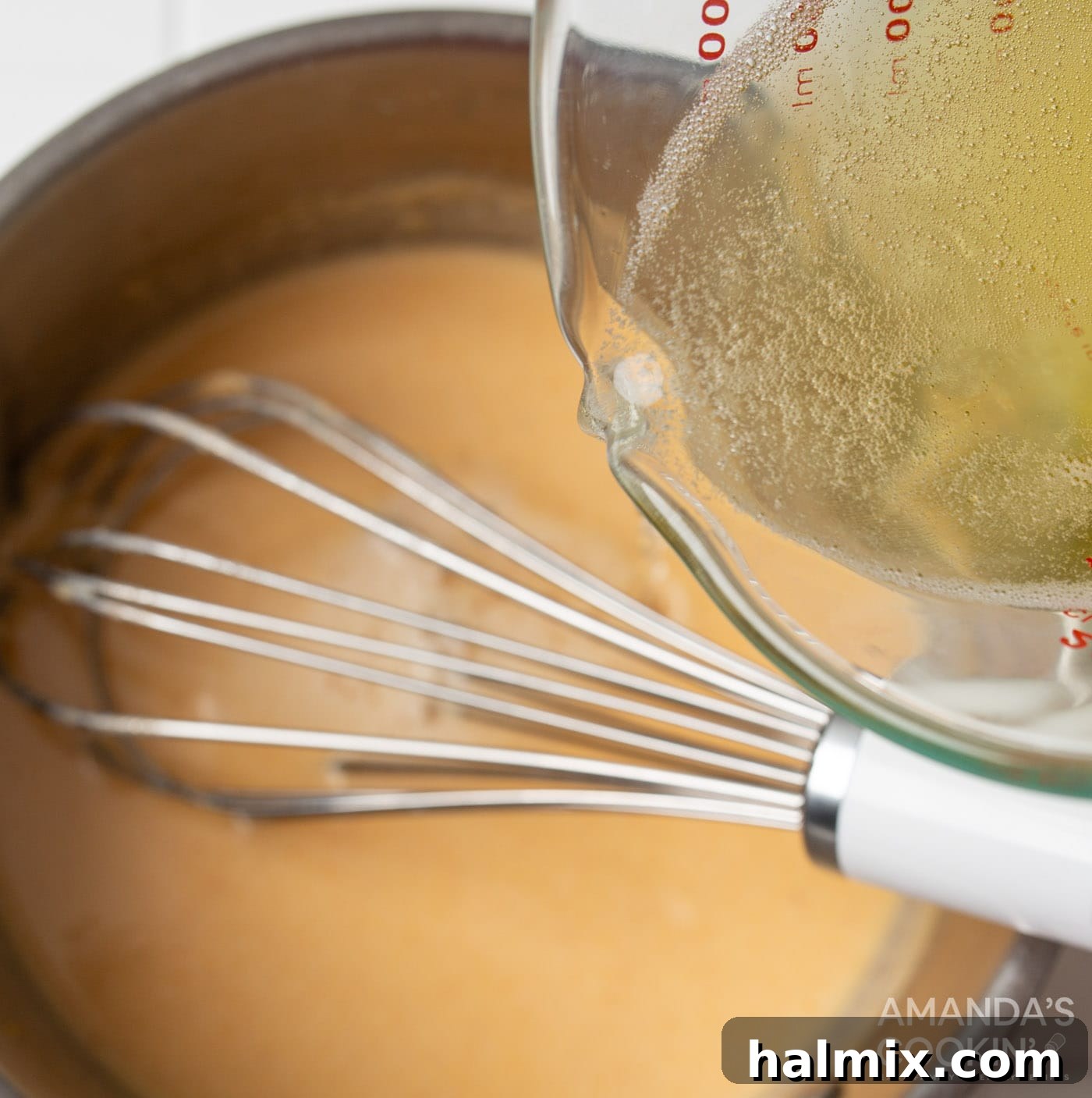 pouring beer into roux