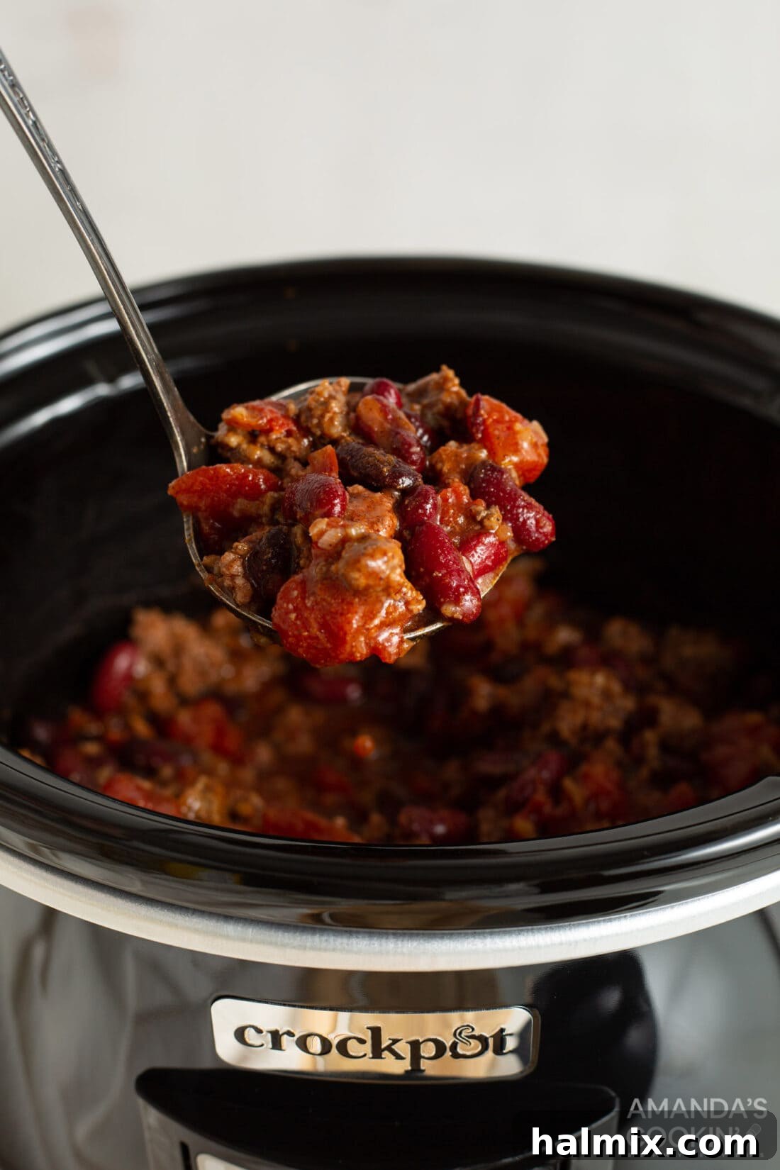 Hearty Crockpot Chili served in a bowl, garnished with fresh toppings.