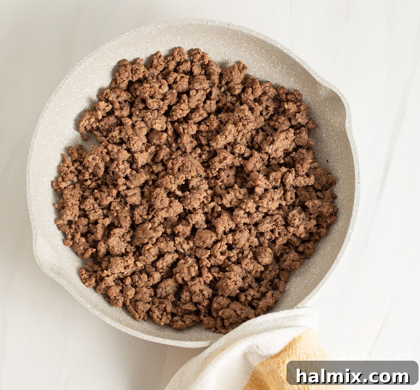 Browned ground beef in a strainer, draining excess fat.