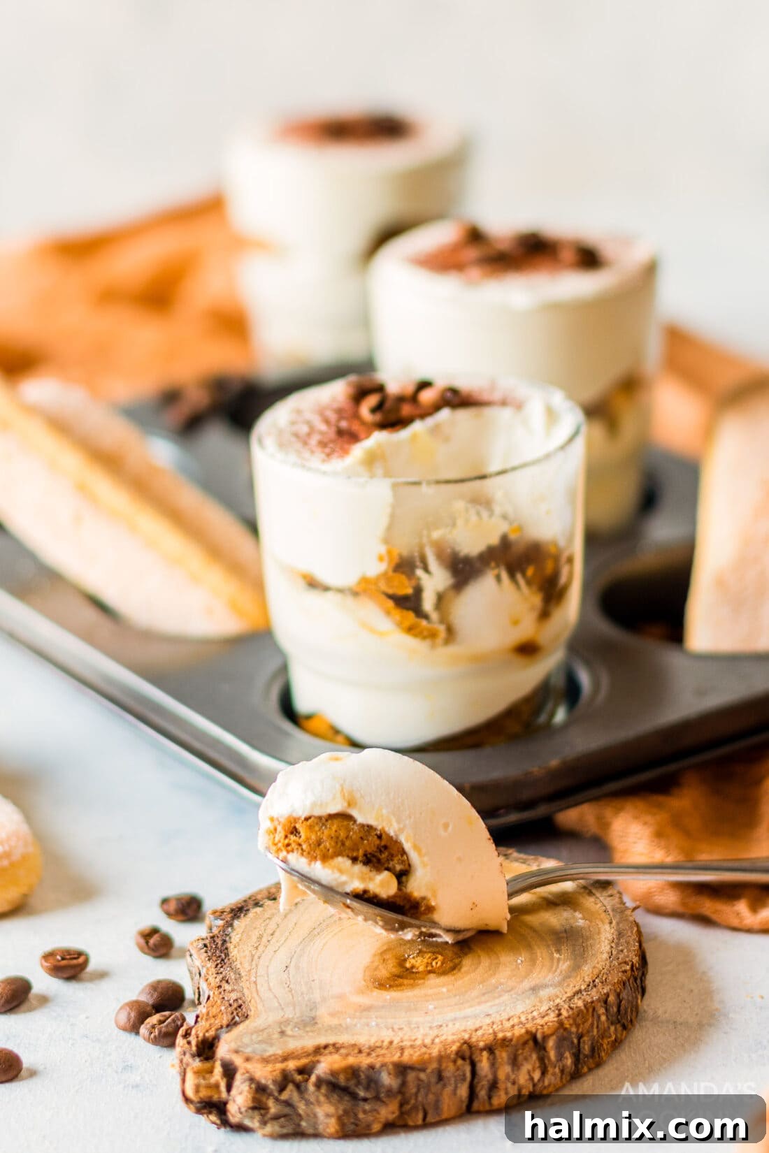 Personal Tiramisu Indulgence 9 Individual Tiramisu with a spoon removed, showing the creamy layers.