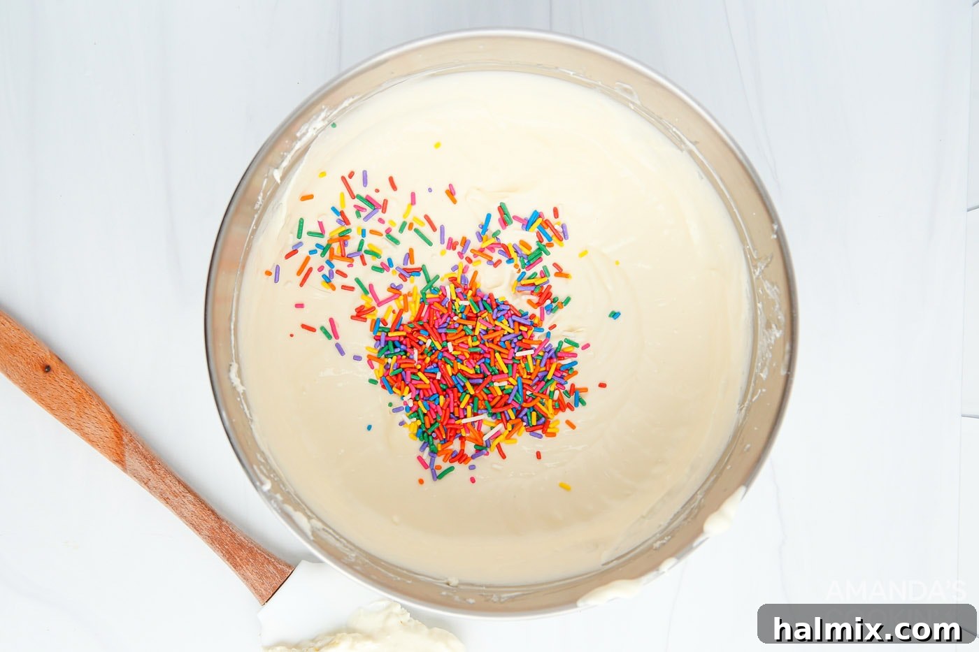 Smooth cream cheese mixture with colorful funfetti sprinkles folded in, ready for the crust.