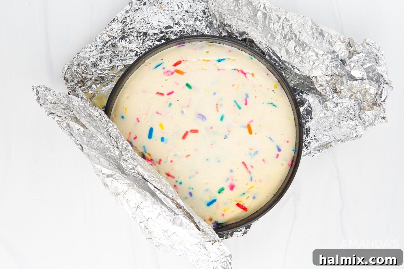 Instant Pot Funfetti Cheesecake cooling after being unwrapped from foil.