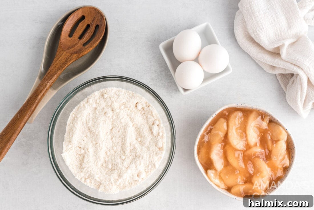 3-Ingredient Apple Pie Bites 4 All the simple ingredients laid out for 3-Ingredient Apple Pie Cupcakes: cake mix, apple pie filling, and eggs.