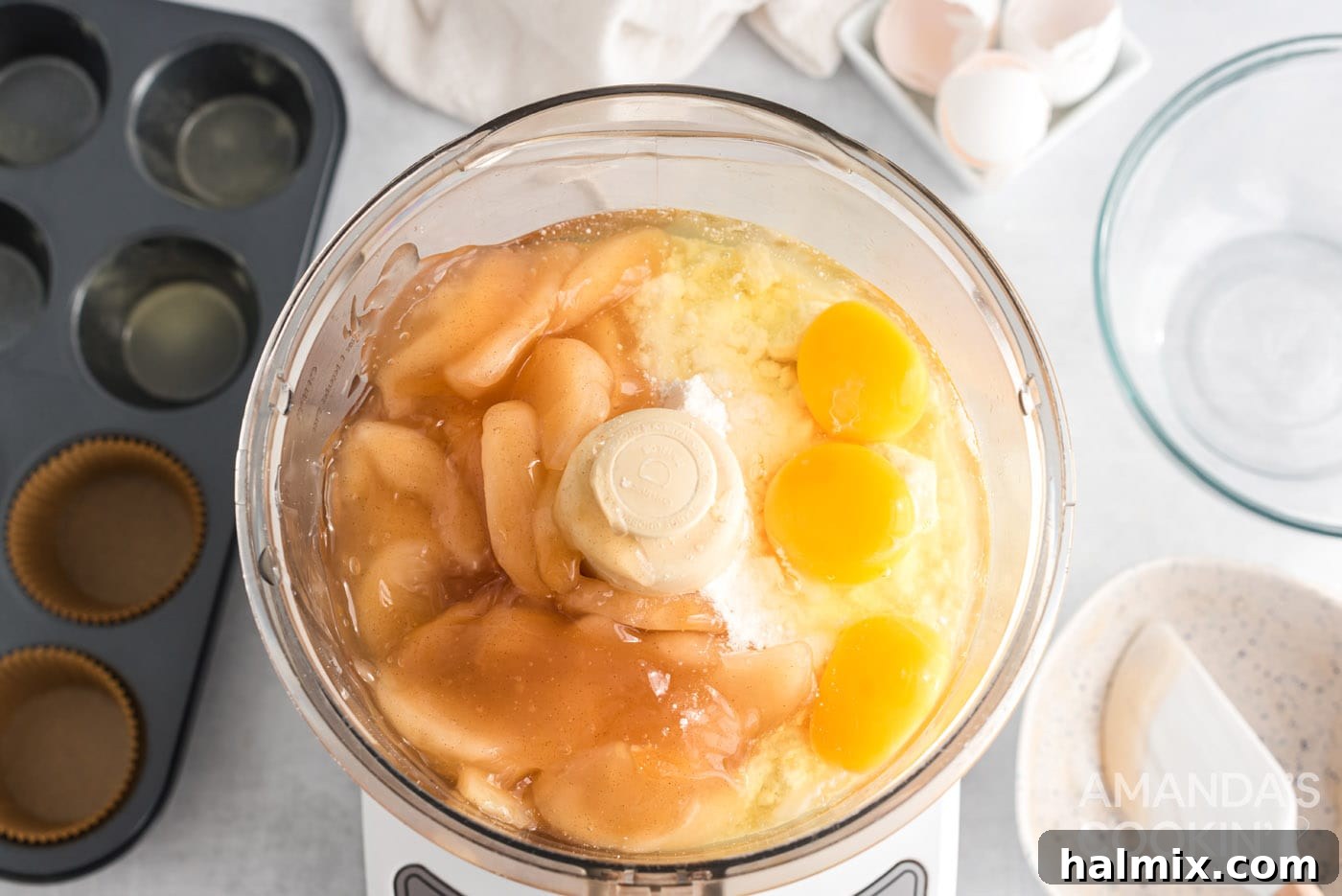 3-Ingredient Apple Pie Bites 5 Eggs, cake mix, and apple pie filling being combined in a food processor for the cupcake batter.