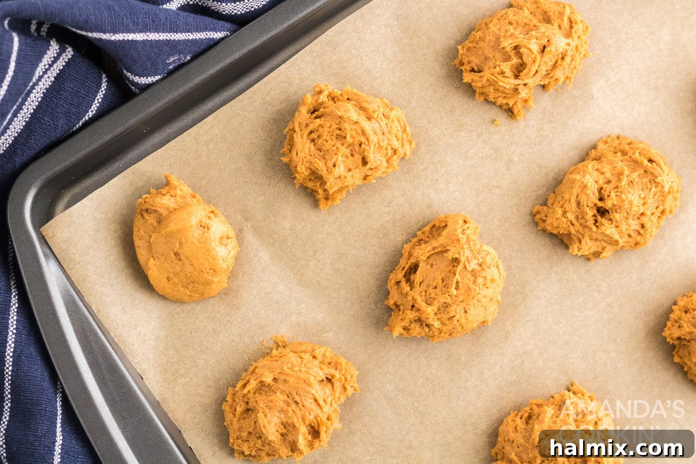 Delicious Pumpkin Cake Mix Treats 7 Pumpkin cookie dough carefully spooned onto a parchment-lined baking sheet