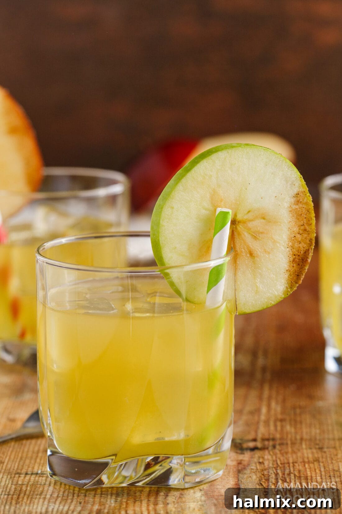 Cinnamon Applesauce Cocktail in a rock glass with apple garnish