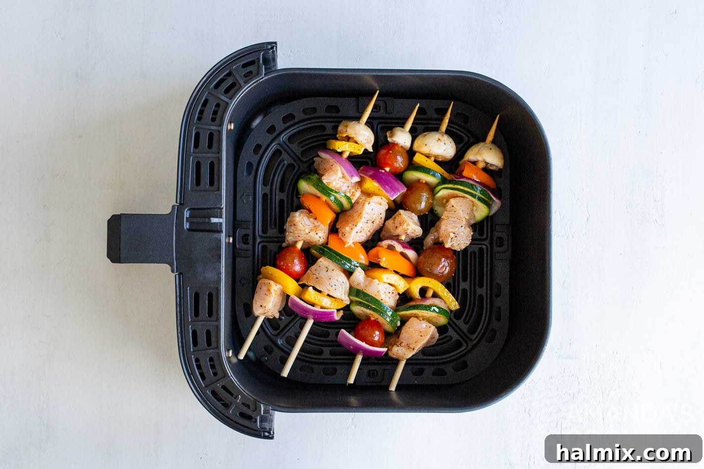 chicken kabobs in an air fryer basket