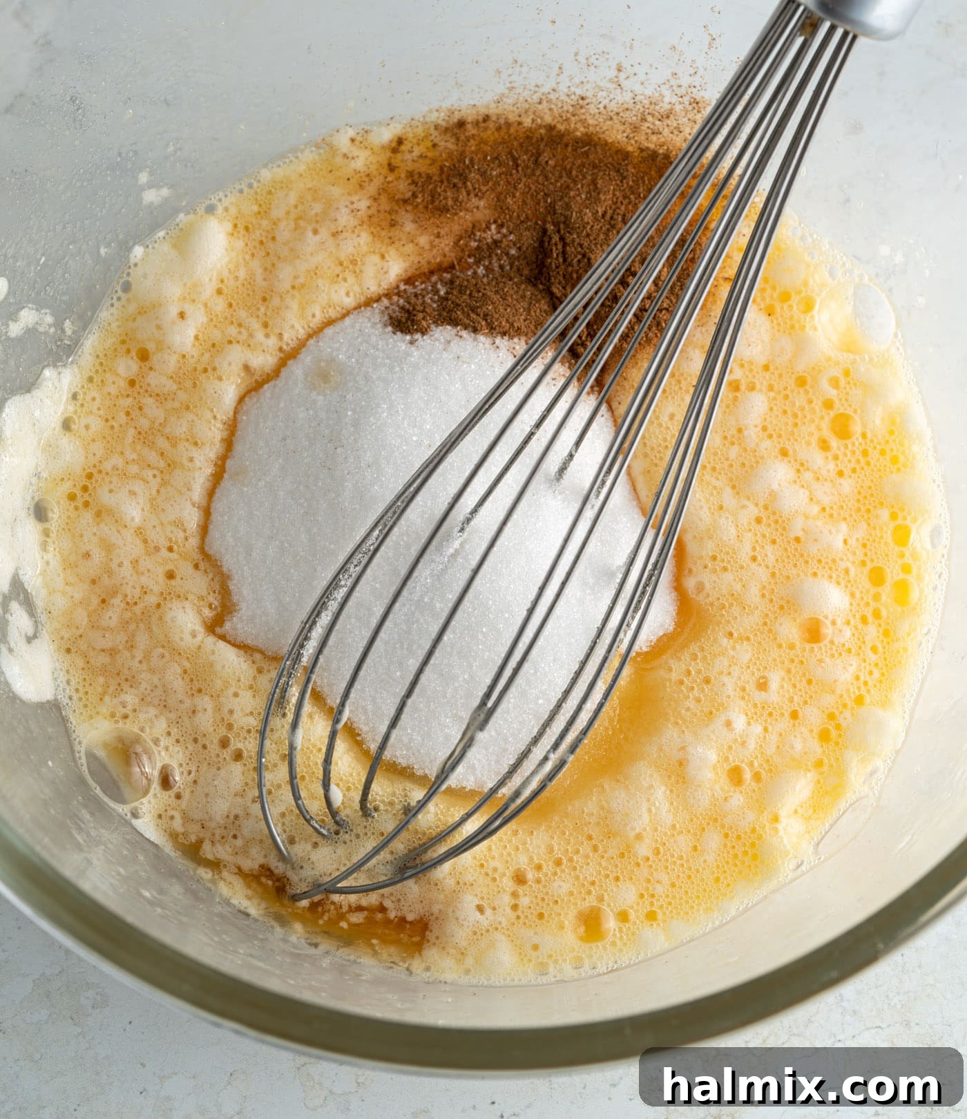 apple pancake batter with a whisk