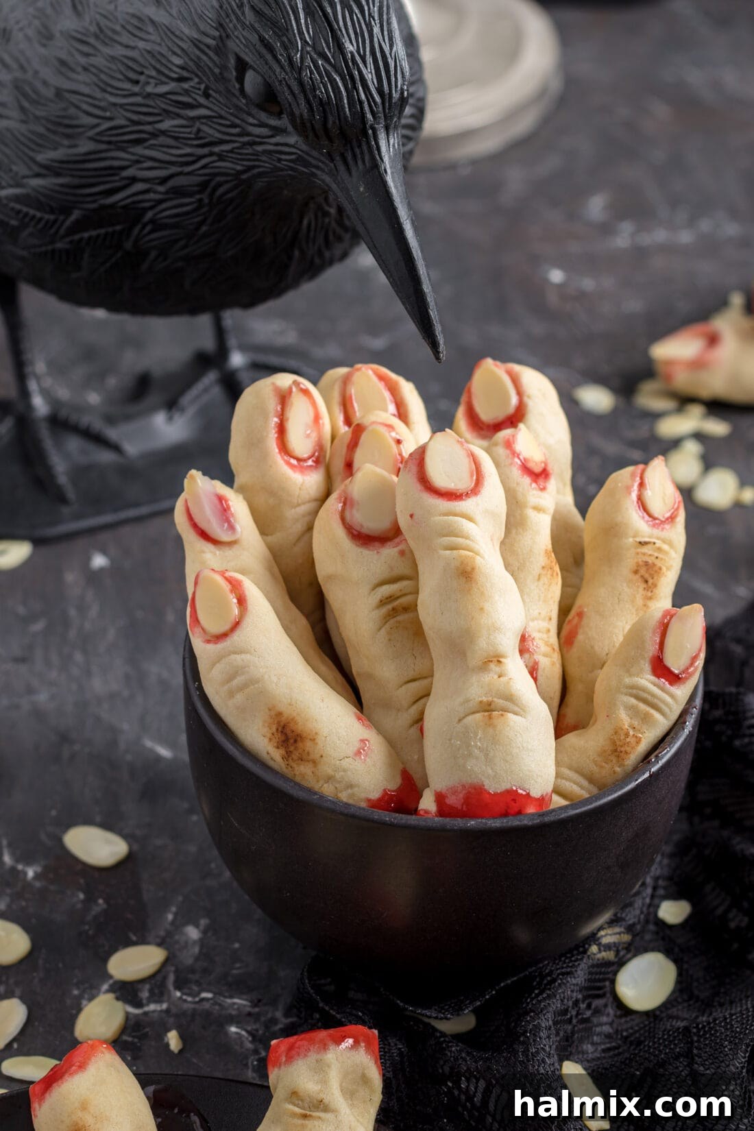Hexed Hand Delights 2 Grotesque Witch Finger Cookies arranged in a decorative dish, ready to terrify and delight Halloween party guests.