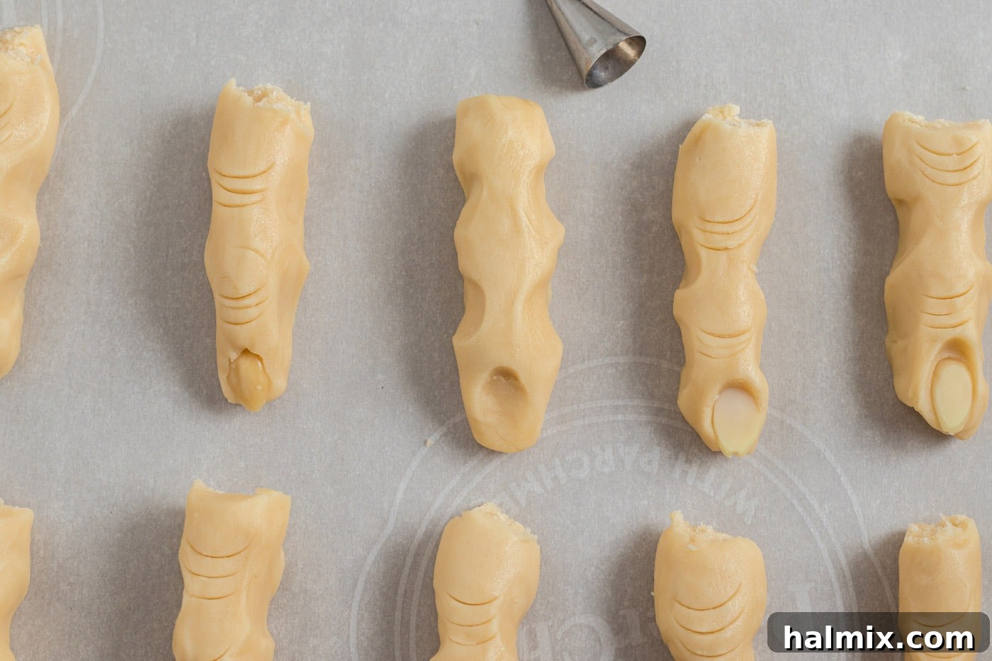 Hexed Hand Delights 11 Close-up of cookie dough with a created indent for the nail bed, ready to receive a sliced almond.