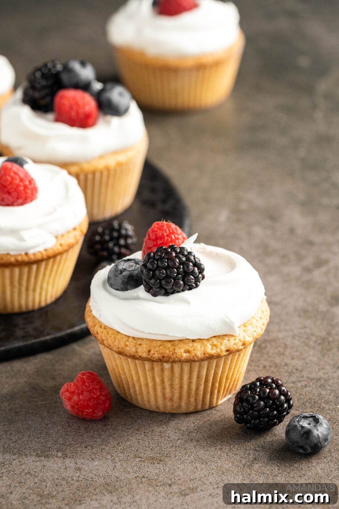 Pound Cake Minis 11 A vibrant display of Pound Cake Cupcakes adorned with berries, perfect for a gathering