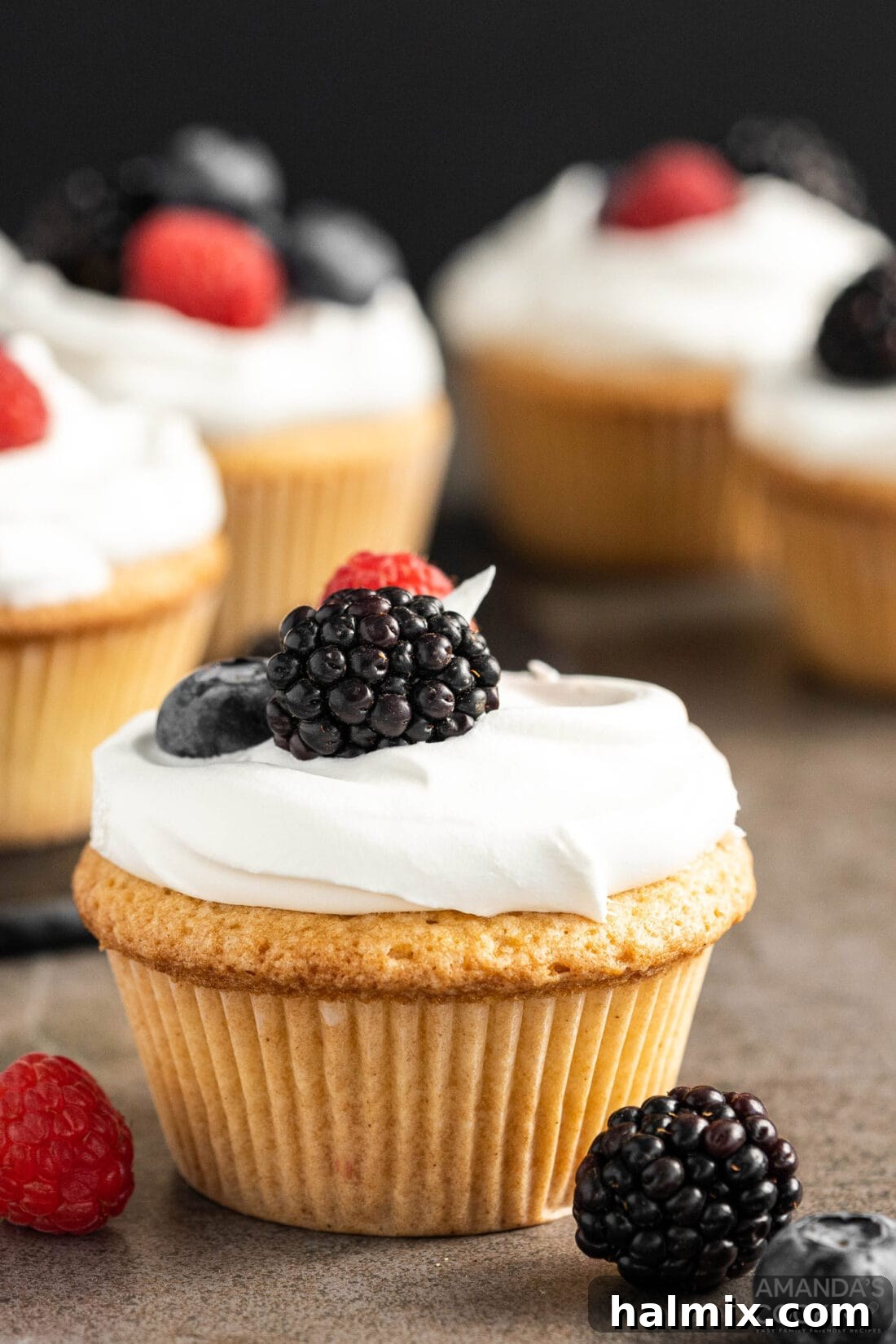 Pound Cake Minis 3 Close-up of a single Pound Cake Cupcake with a fresh berry garnish