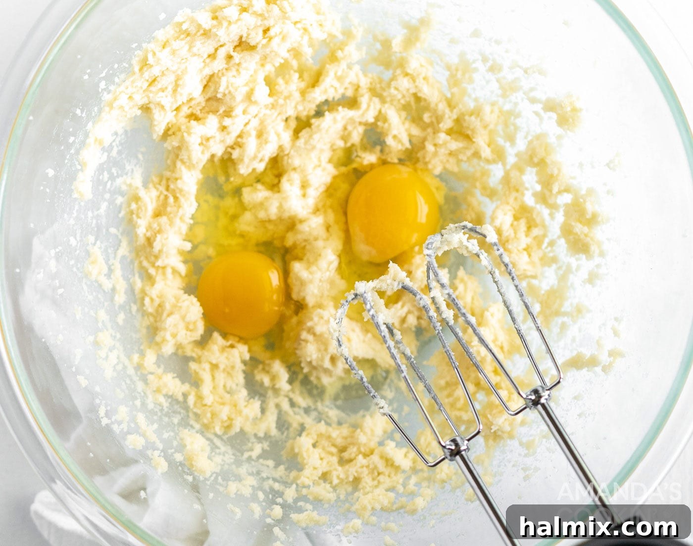 Pound Cake Minis 6 Hand mixer beating eggs into the cupcake batter