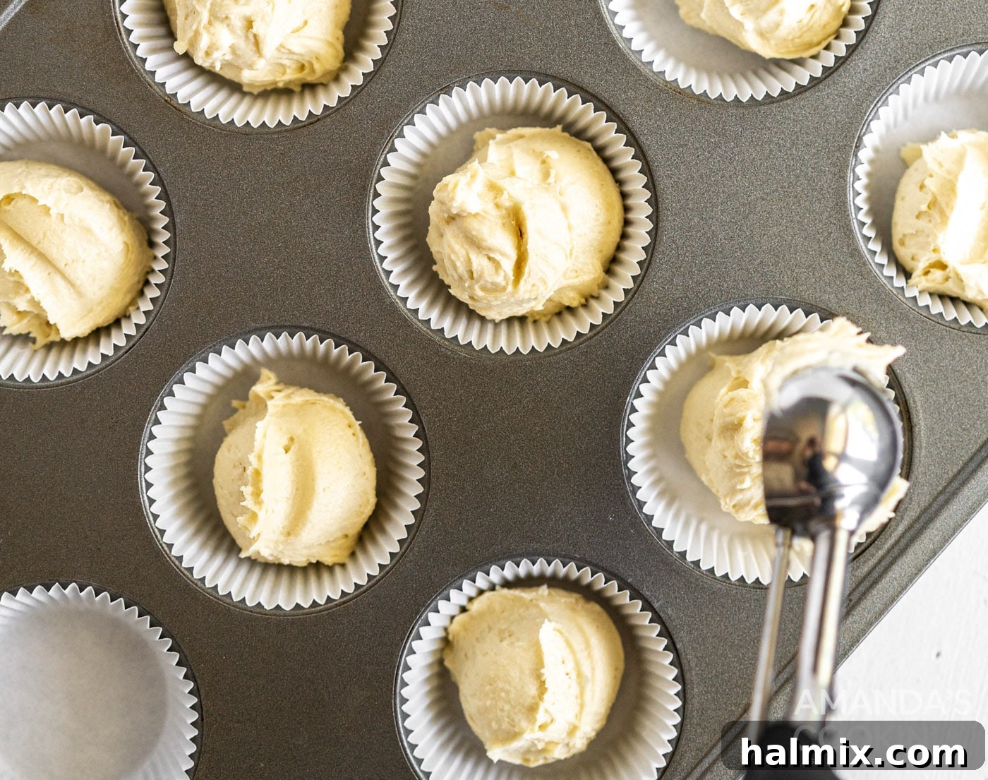 Pound Cake Minis 8 Pound cake batter being spooned into a muffin tin