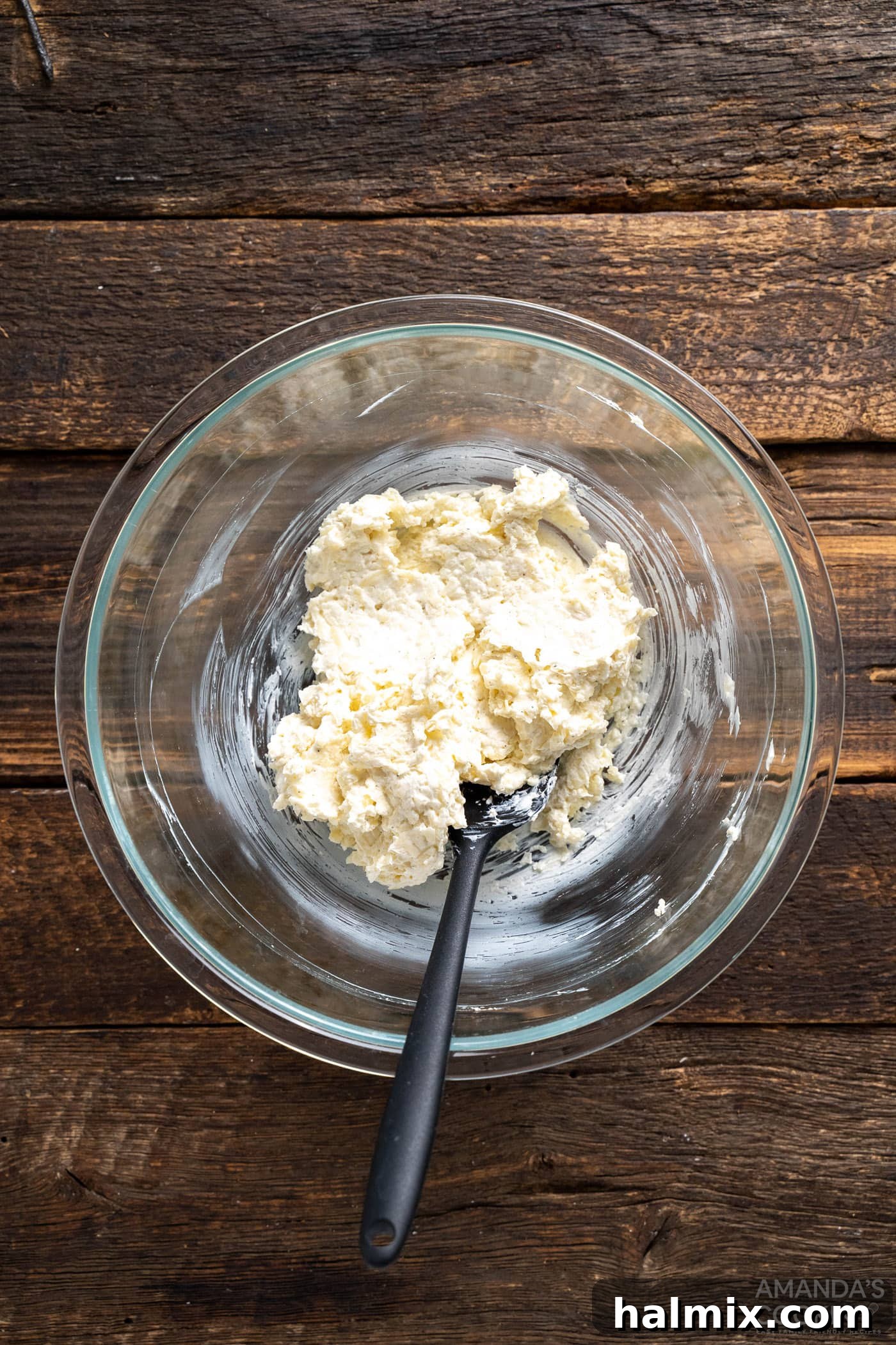 Cream cheese, Monterey Jack cheese, and seasonings mixed in a bowl, showing the creamy filling's consistency