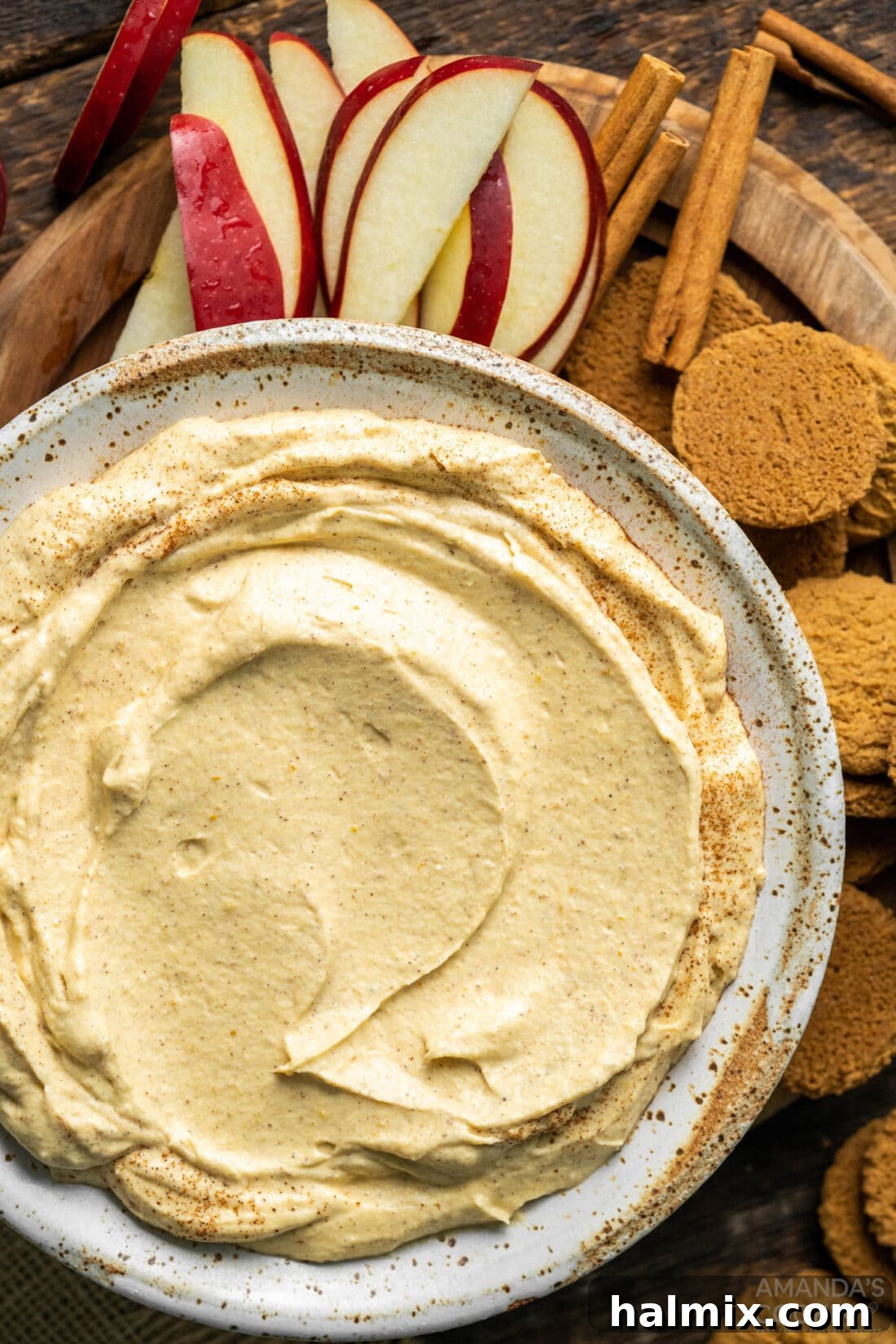 A beautifully presented bowl of creamy Pumpkin Pie Dip, ready to be enjoyed with a variety of dippers, evoking the cozy spirit of fall.