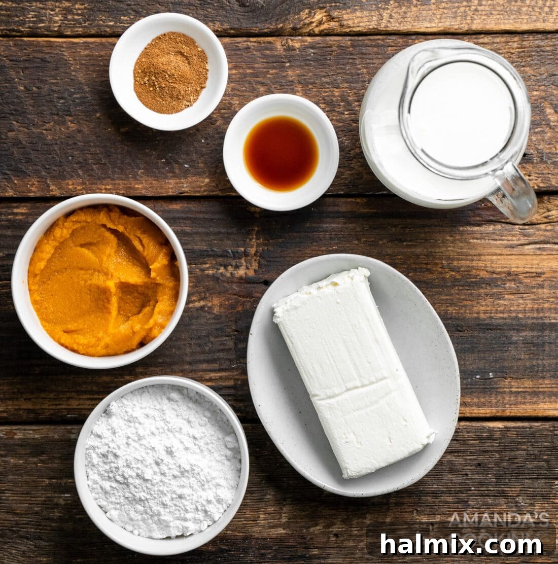 A neat arrangement of the six core ingredients for No-Bake Pumpkin Pie Dip, showcasing cream cheese, pumpkin puree, powdered sugar, pumpkin spice, vanilla extract, and heavy cream.