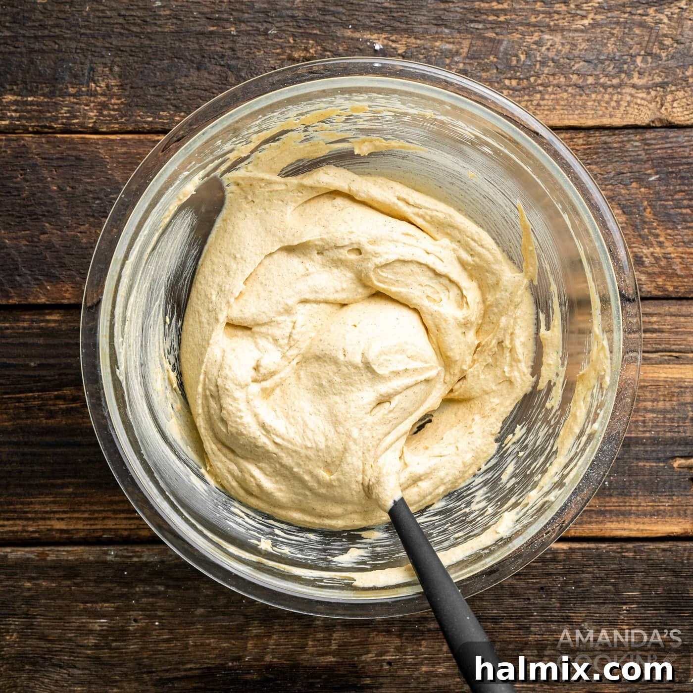 The finished Pumpkin Pie Dip, beautifully presented in a mixing bowl with a spoon, showcasing its inviting texture and ready for serving.