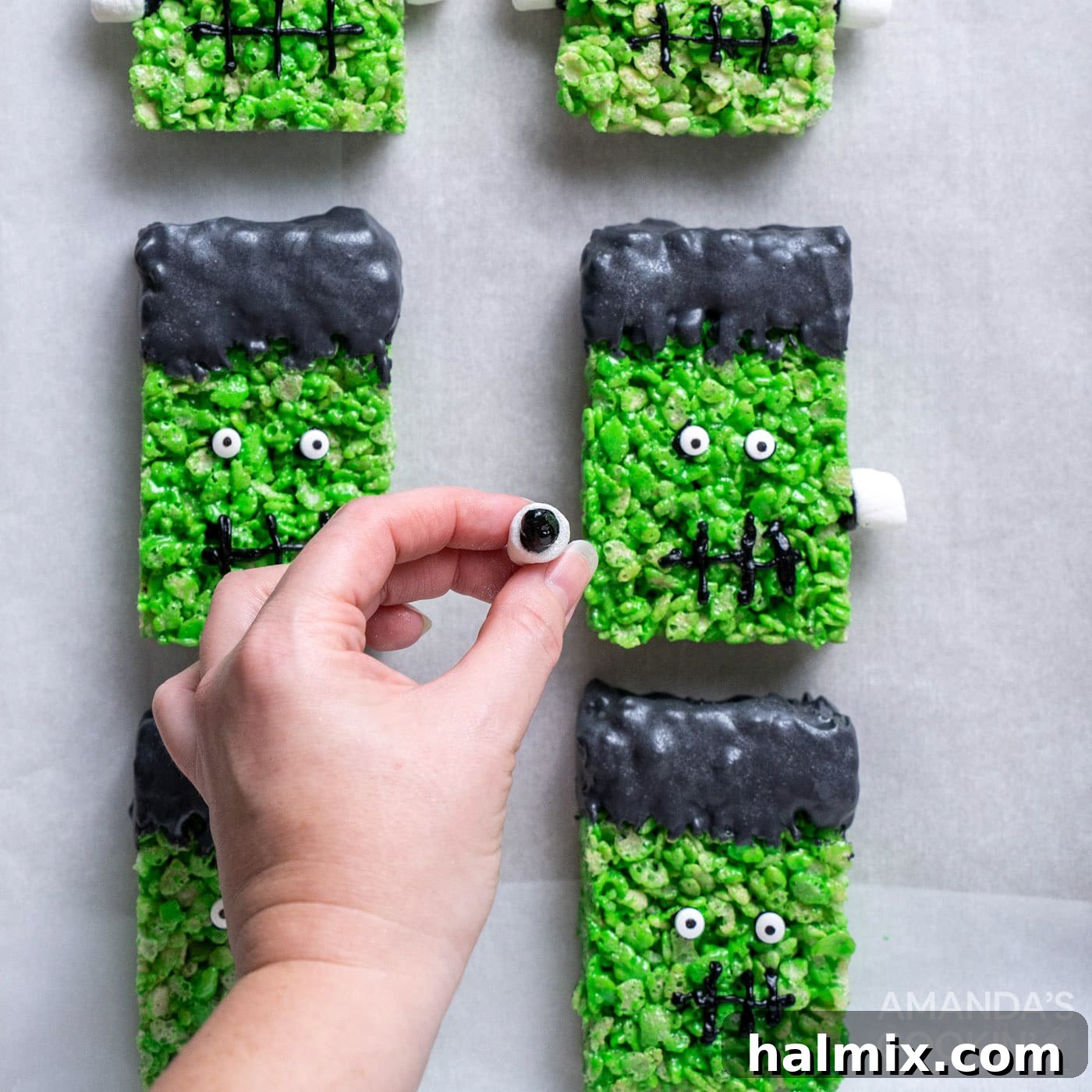 Frankenstein's Krispie Creations 15 Hand attaching mini marshmallows to Frankenstein rice krispie treats