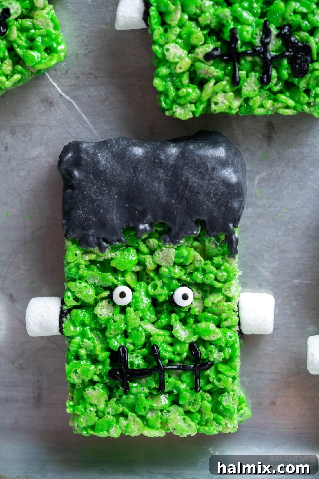 Frankenstein's Krispie Creations 3 Frankenstein Rice Krispie Treats on a cookie sheet