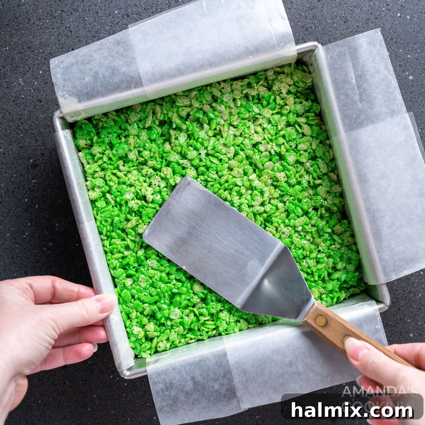 Frankenstein's Krispie Creations 9 Spatula patting flat rice krispie treats
