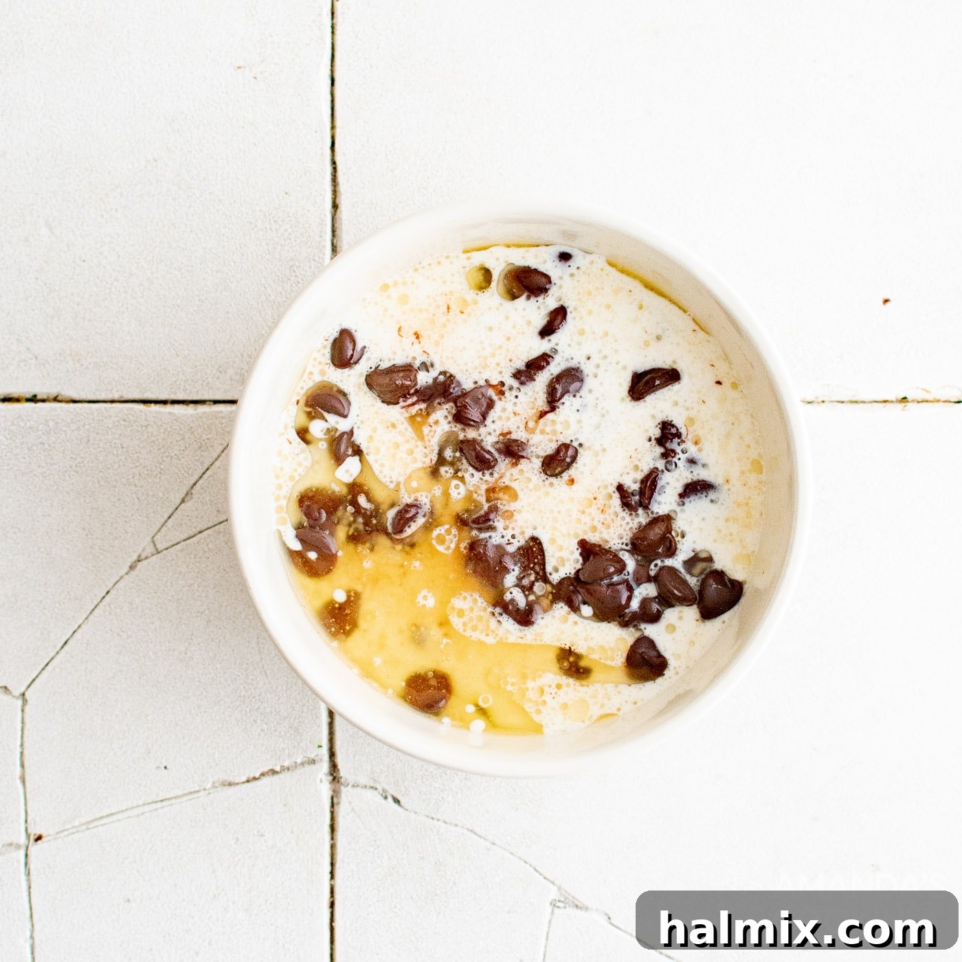 heavy cream and butter in a bowl of chocolate chips, ready for melting.