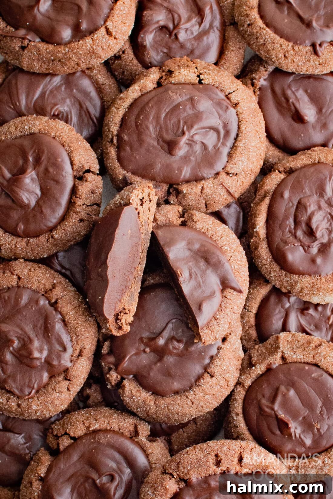 Chocolate Thumbprint Cookies cut in half, revealing the perfect cross-section of cookie and filling.