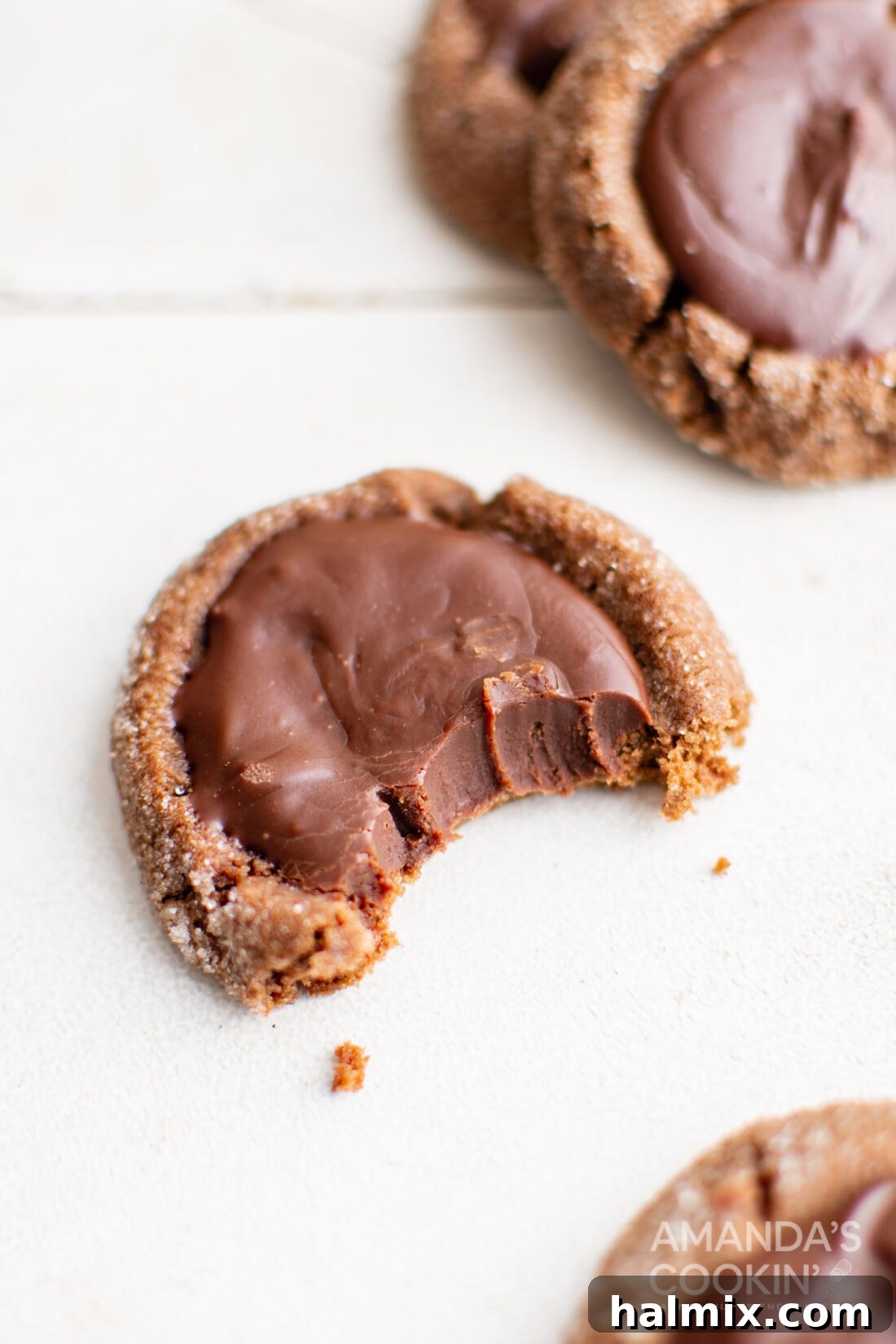 Chocolate Thumbprint Cookie with a bite taken out, highlighting the soft interior.