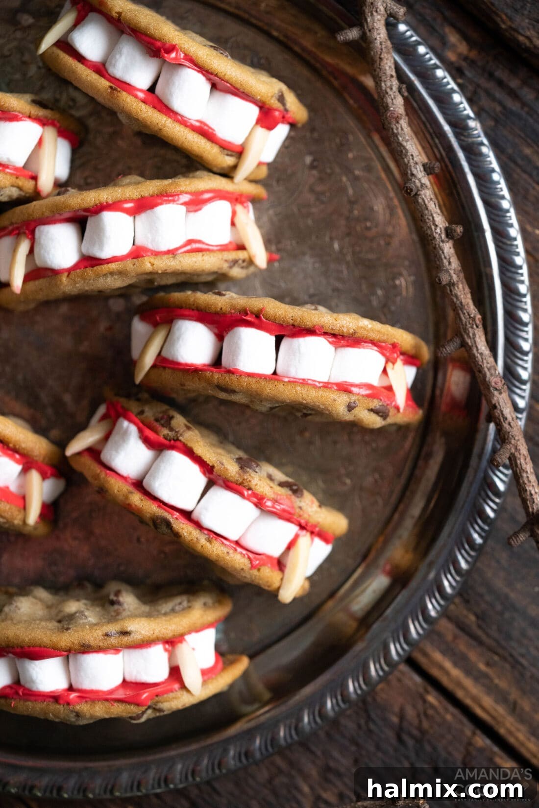 Two Vampire Sandwich Cookies on a white plate, highlighting their distinct design and spooky aesthetics.