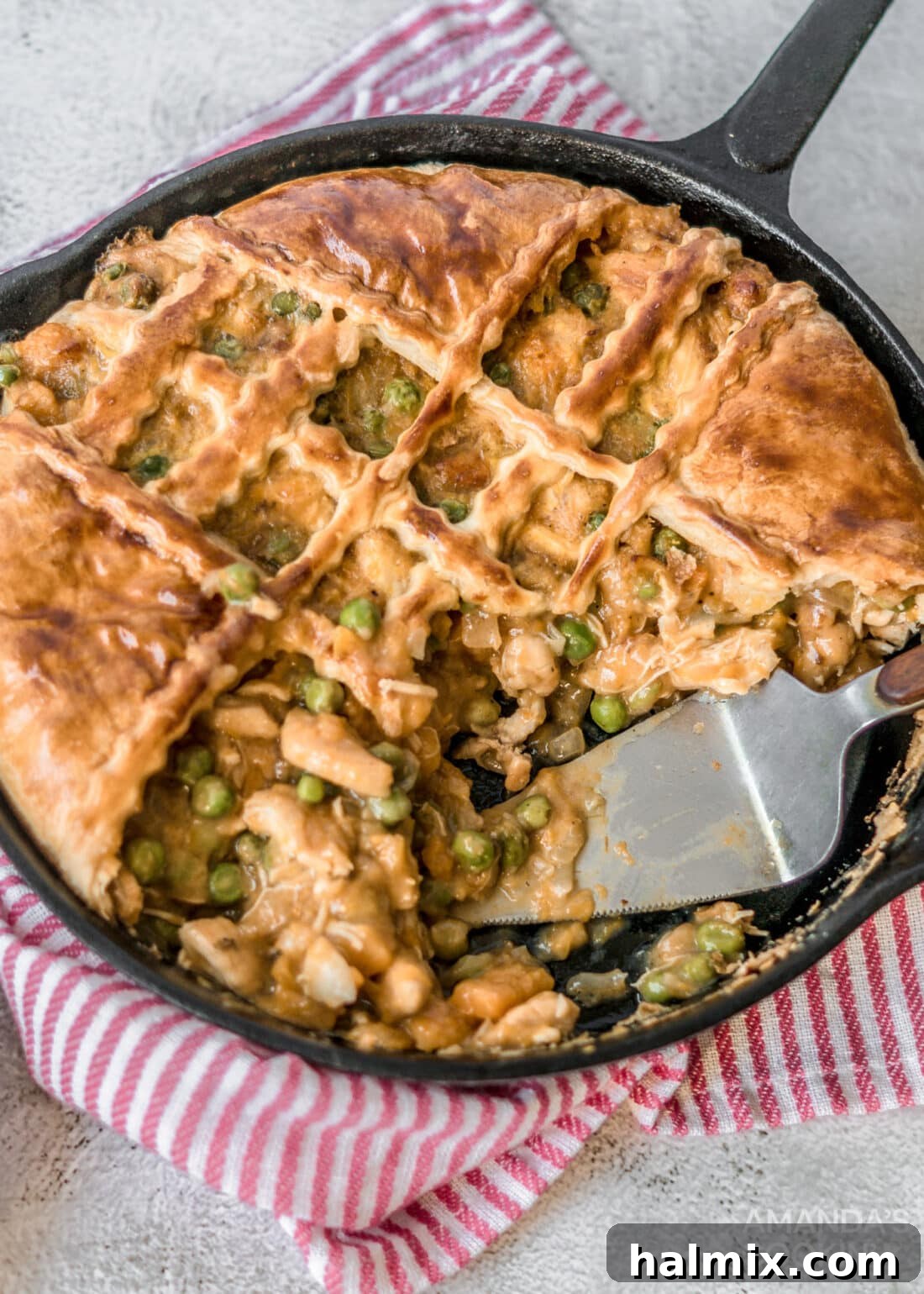 Hearty skillet of golden Pumpkin Chicken Pot Pie, bubbling with deliciousness and topped with flaky pastry