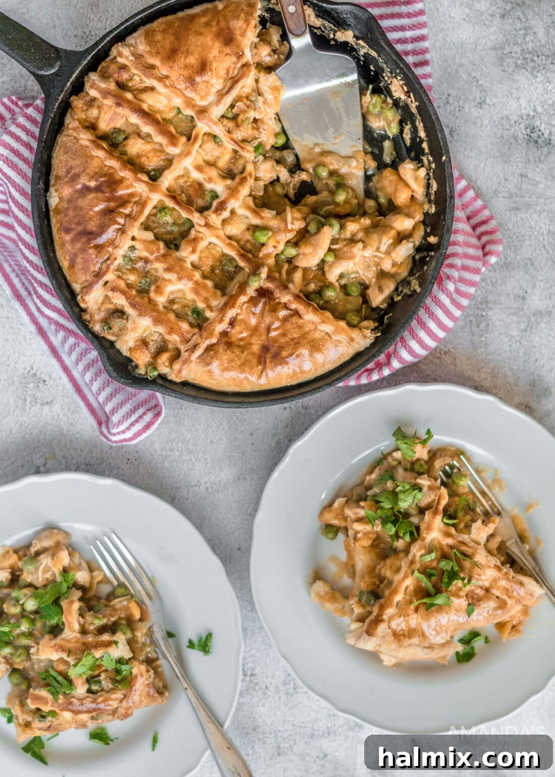 Two plates of perfectly portioned Pumpkin Chicken Pot Pie, garnished and ready to be enjoyed