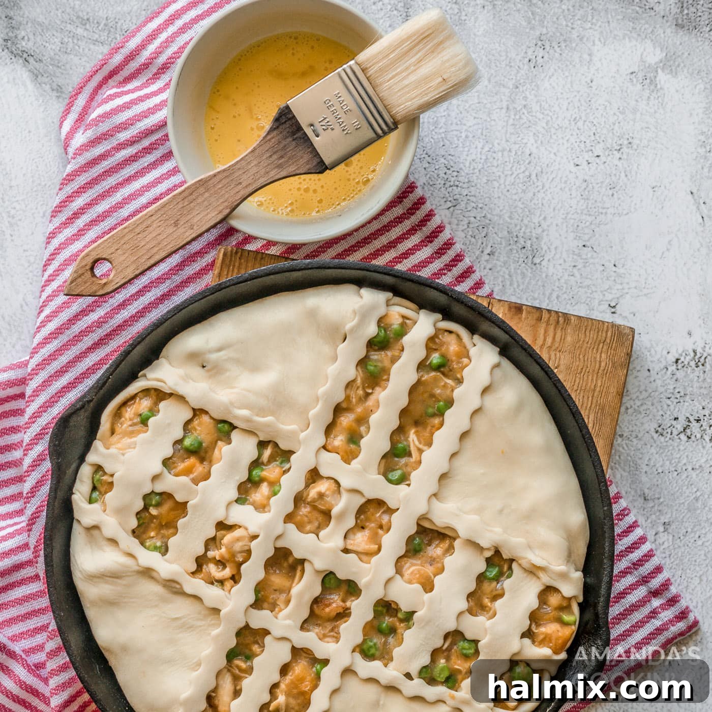 Artfully arranged puff pastry lattice topping a Pumpkin Chicken Pot Pie, ready for baking