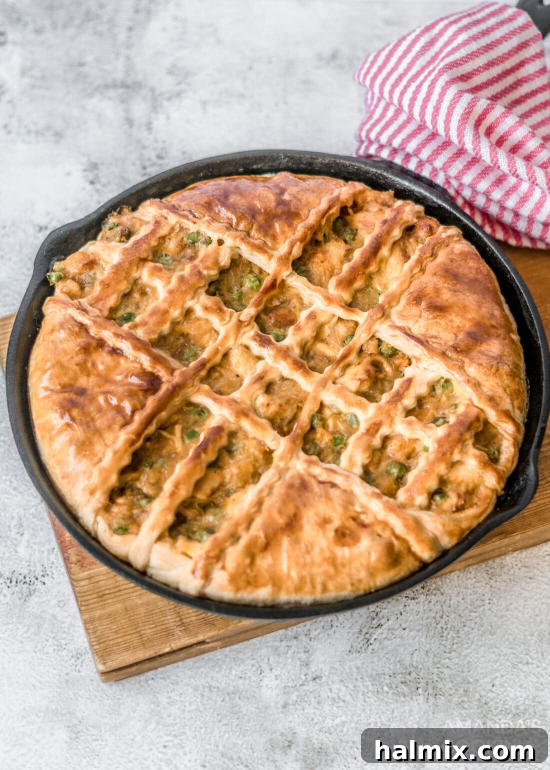 A large skillet of golden brown, freshly baked Pumpkin Chicken Pot Pie, steam gently rising