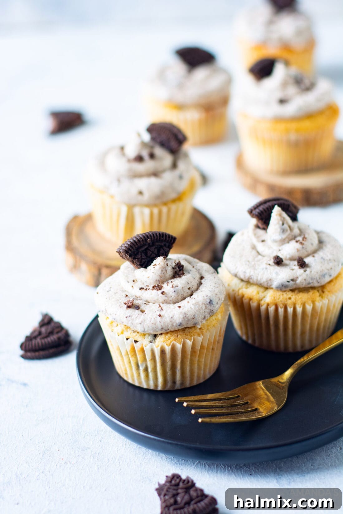 A plate of freshly baked Oreo Cupcakes, beautifully frosted and garnished with cookie pieces, ready to be enjoyed.