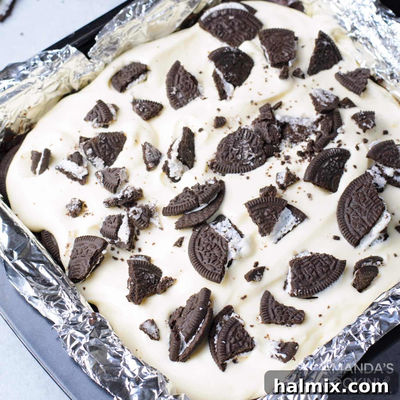 Crushed Oreos sprinkled over the top of the cheesecake layer