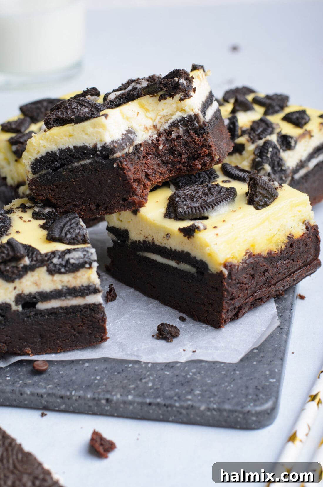 A bite taken out of an Oreo Cheesecake Brownie, revealing its delicious layers