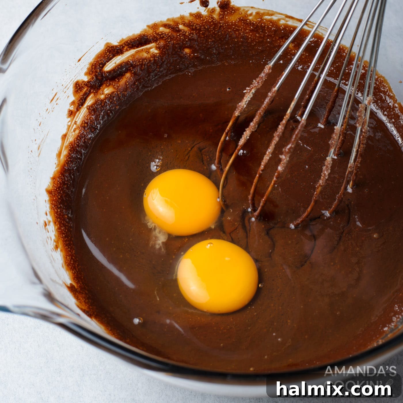 Eggs and vanilla extract whisked into the chocolate brownie batter