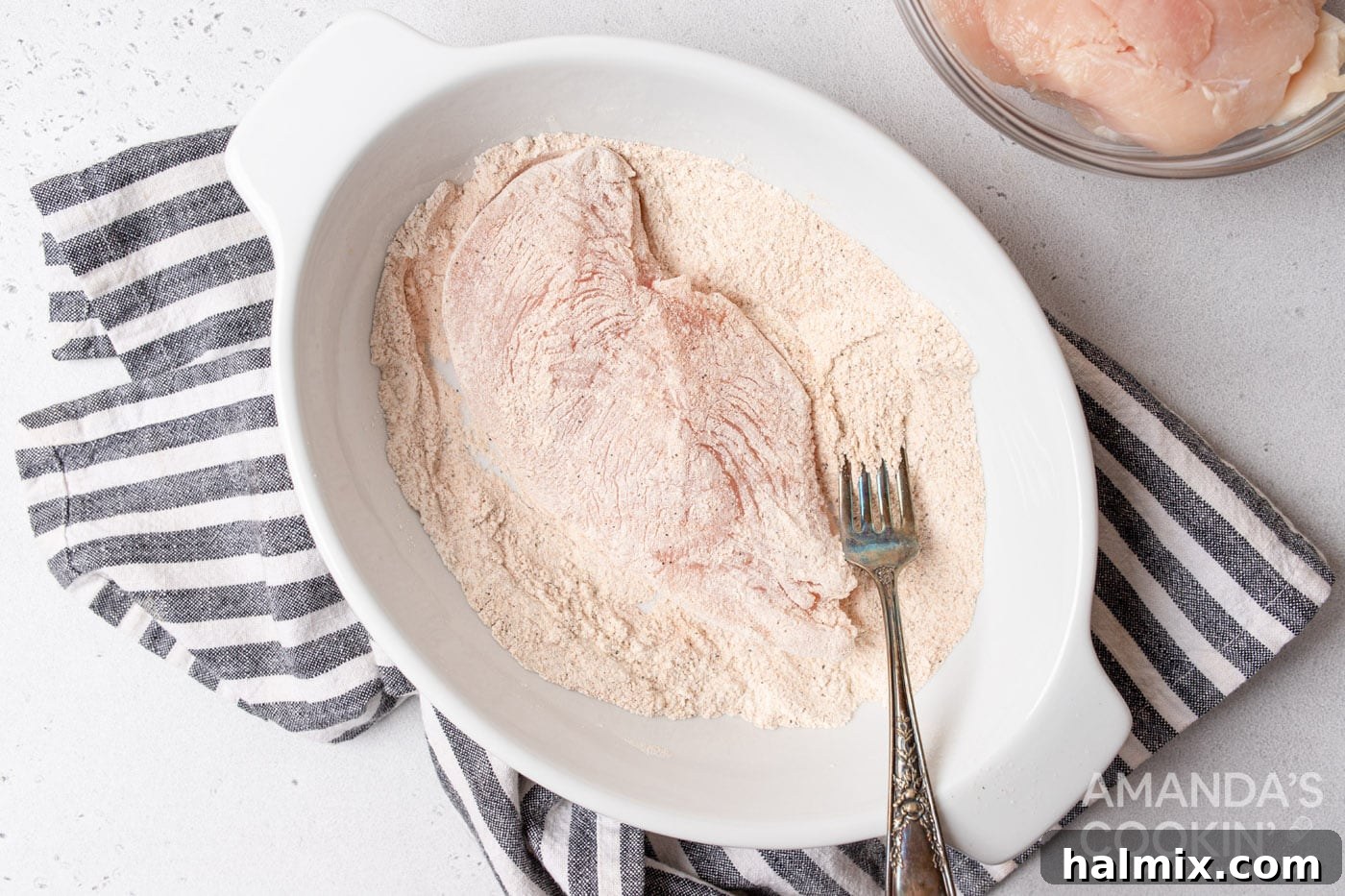 coating chicken breasts in flour mixture
