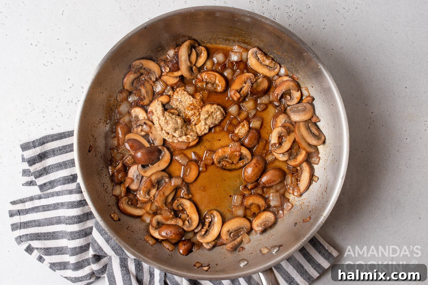 white wine with mushrooms and onions sauteed on a skillet