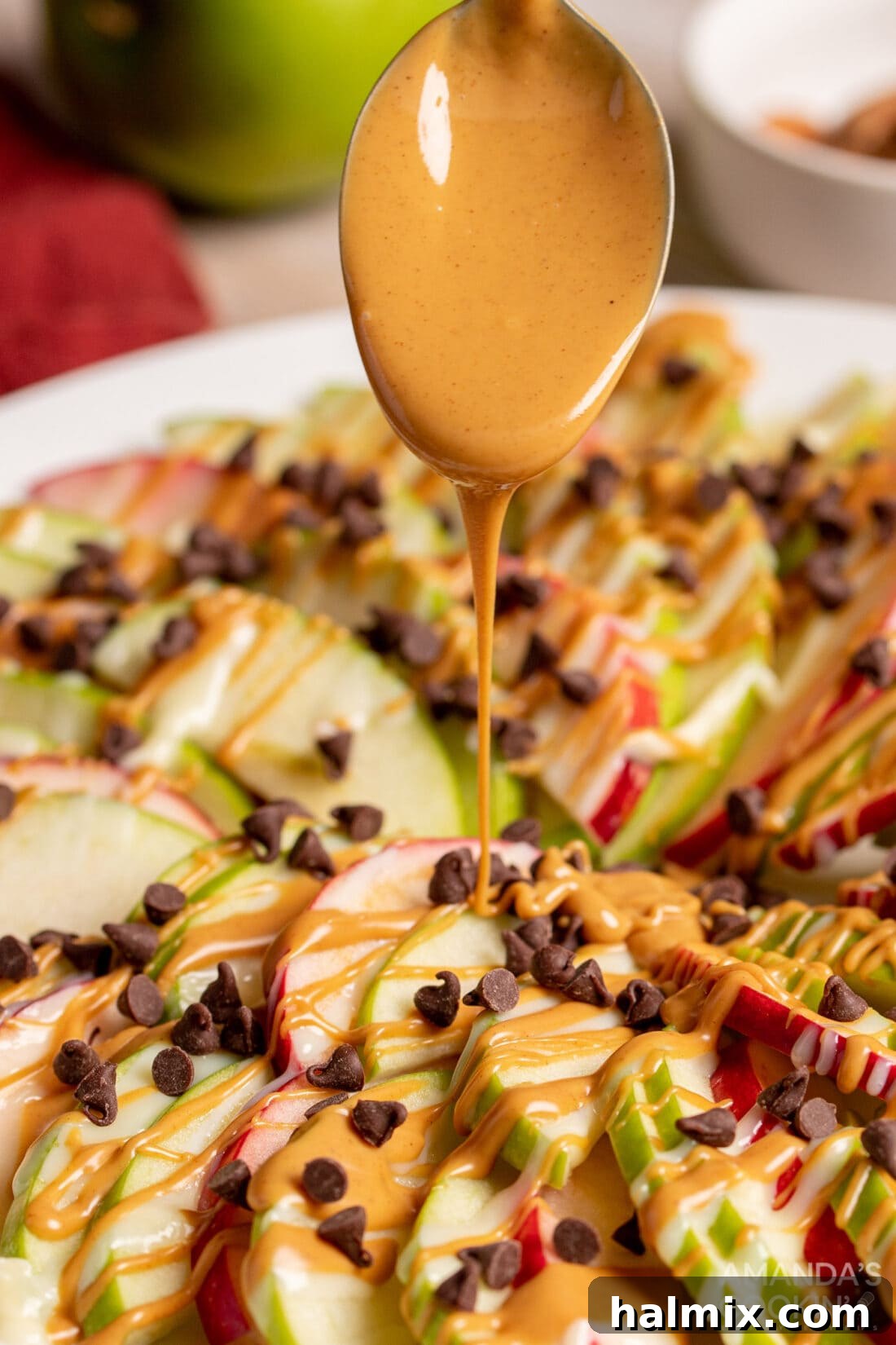 Crisp Apple Stacks 3 drizzle peanut butter on Apple Nachos