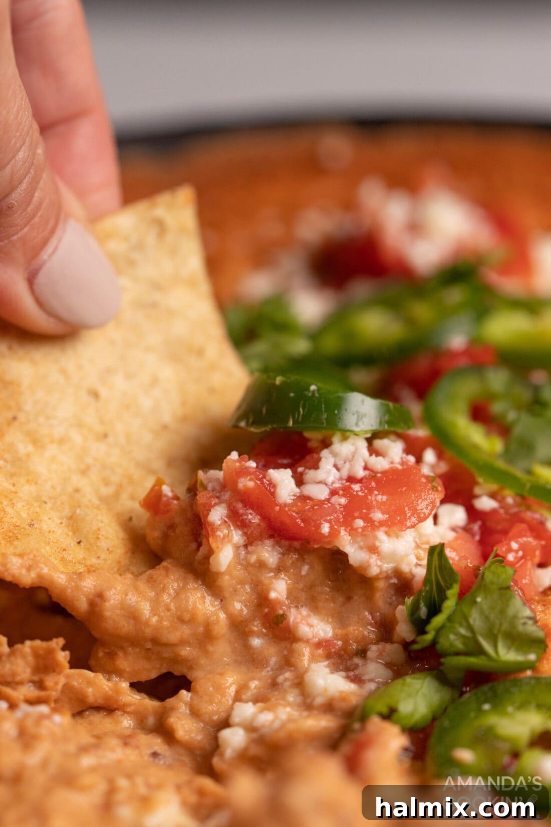 scooping Bean Dip with nacho chip