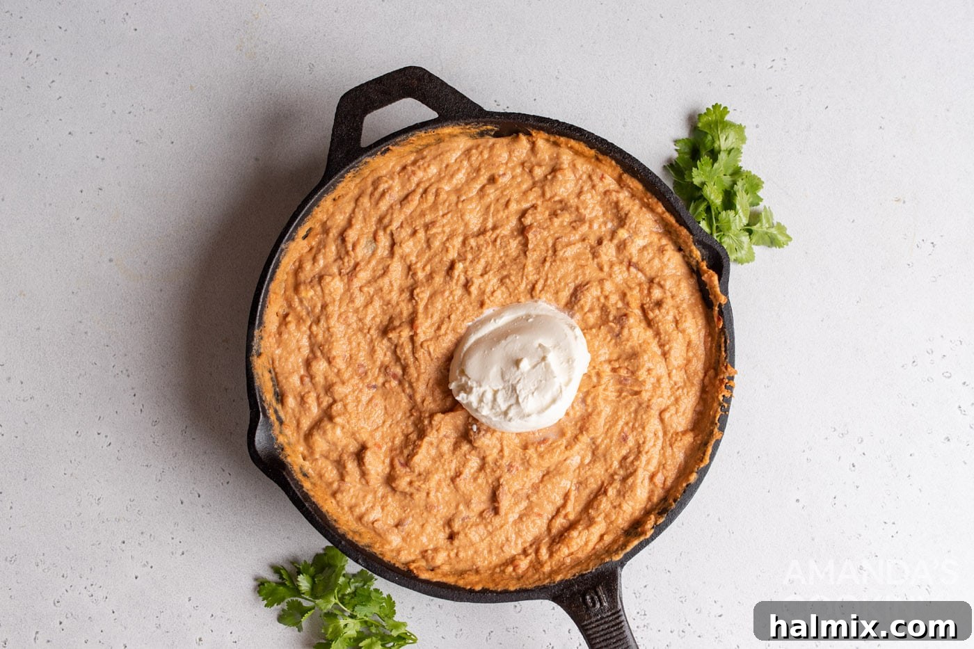 bean dip with sour cream in a skillet