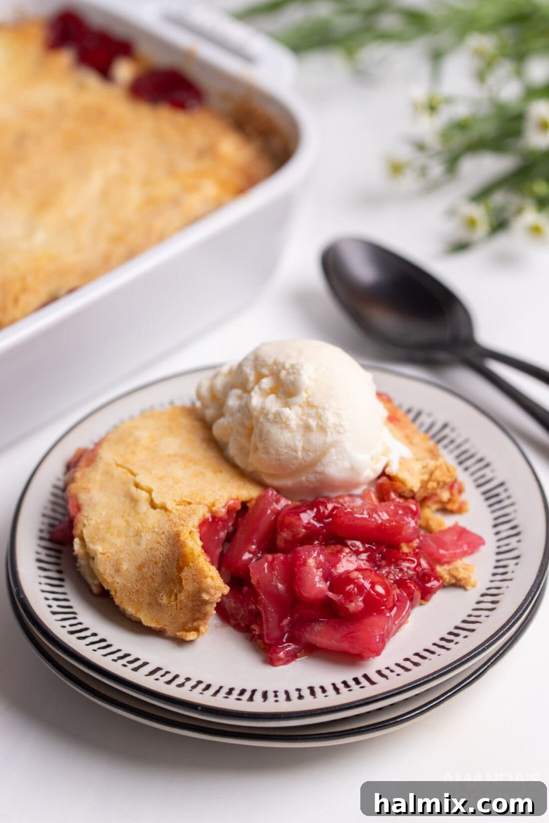 Cherry Pineapple Dump Cake on a plate with ice cream