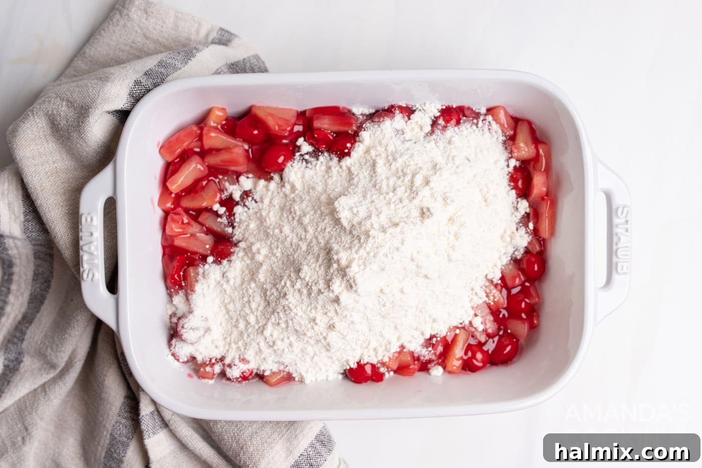 dry yellow cake mix sprinkled over fruit filling in a casserole dish