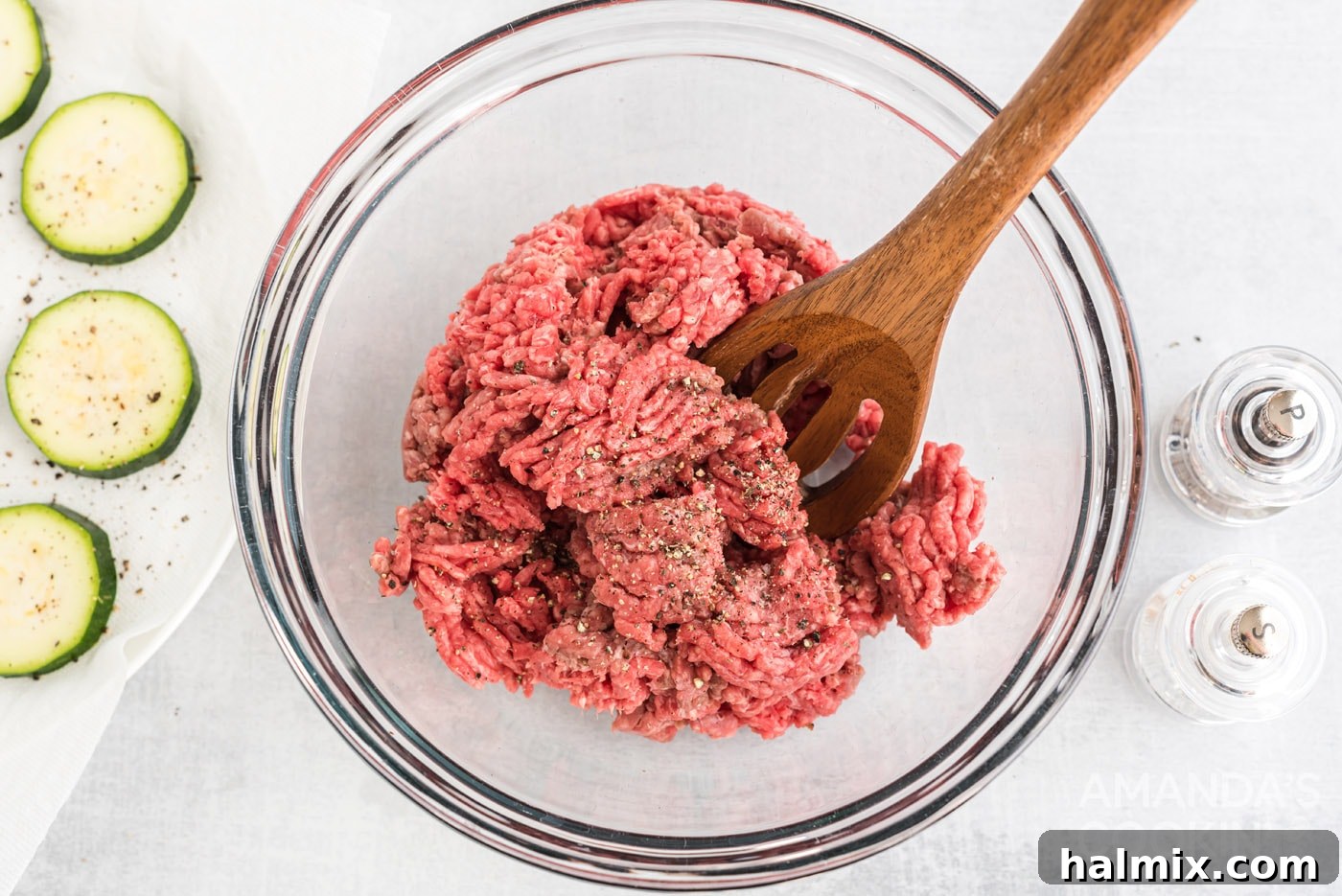 Zucchini Stackers 6 Mixing spoon in a bowl of ground beef with salt and pepper