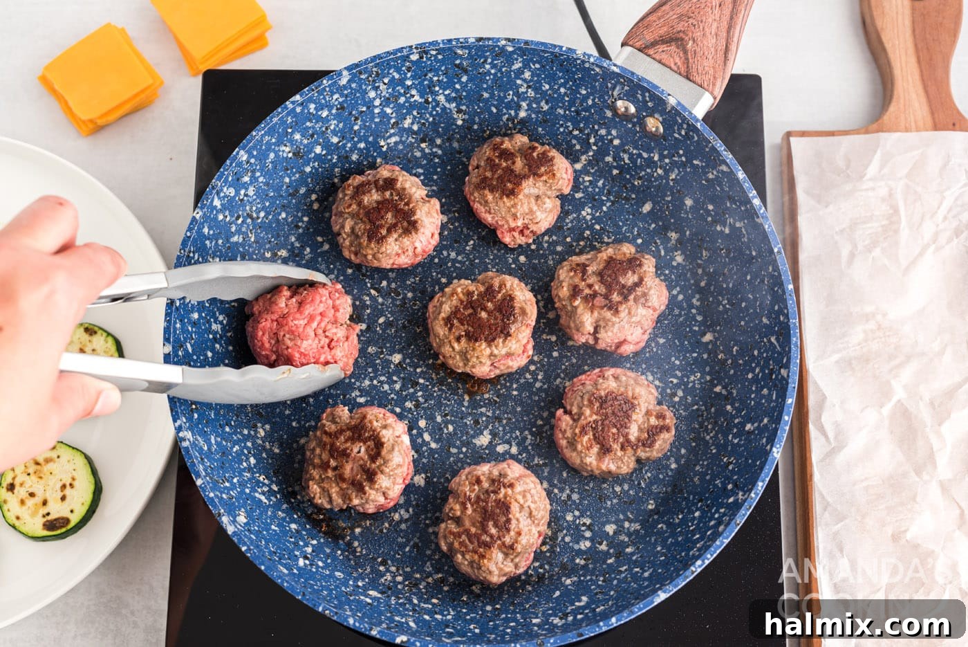 Zucchini Stackers 9 Tongs flipping a mini burger patty in a skillet