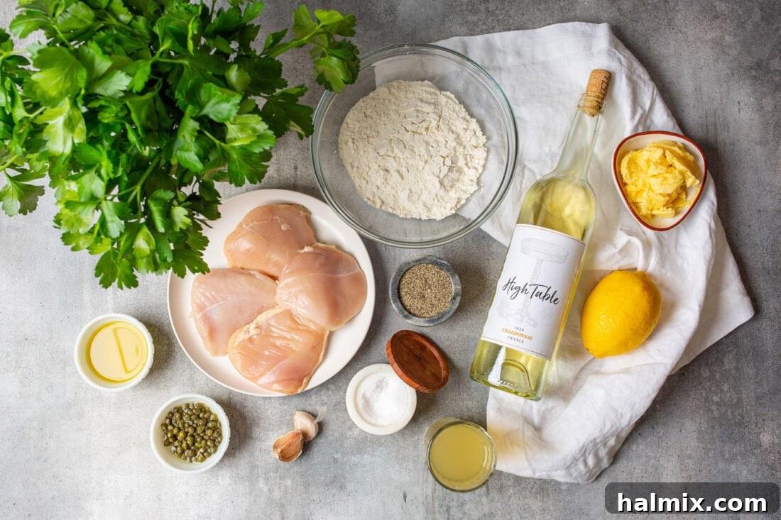 Zesty Lemon Caper Chicken 4 Ingredients for Chicken Piccata laid out on a wooden board