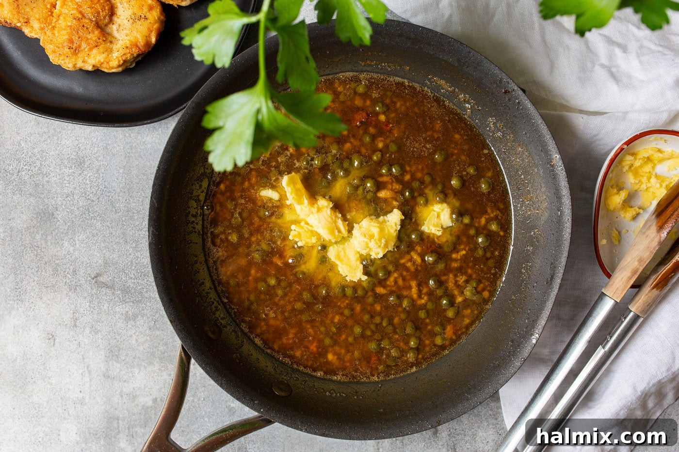 Zesty Lemon Caper Chicken 8 Capers, lemon juice, and garlic simmering in a skillet
