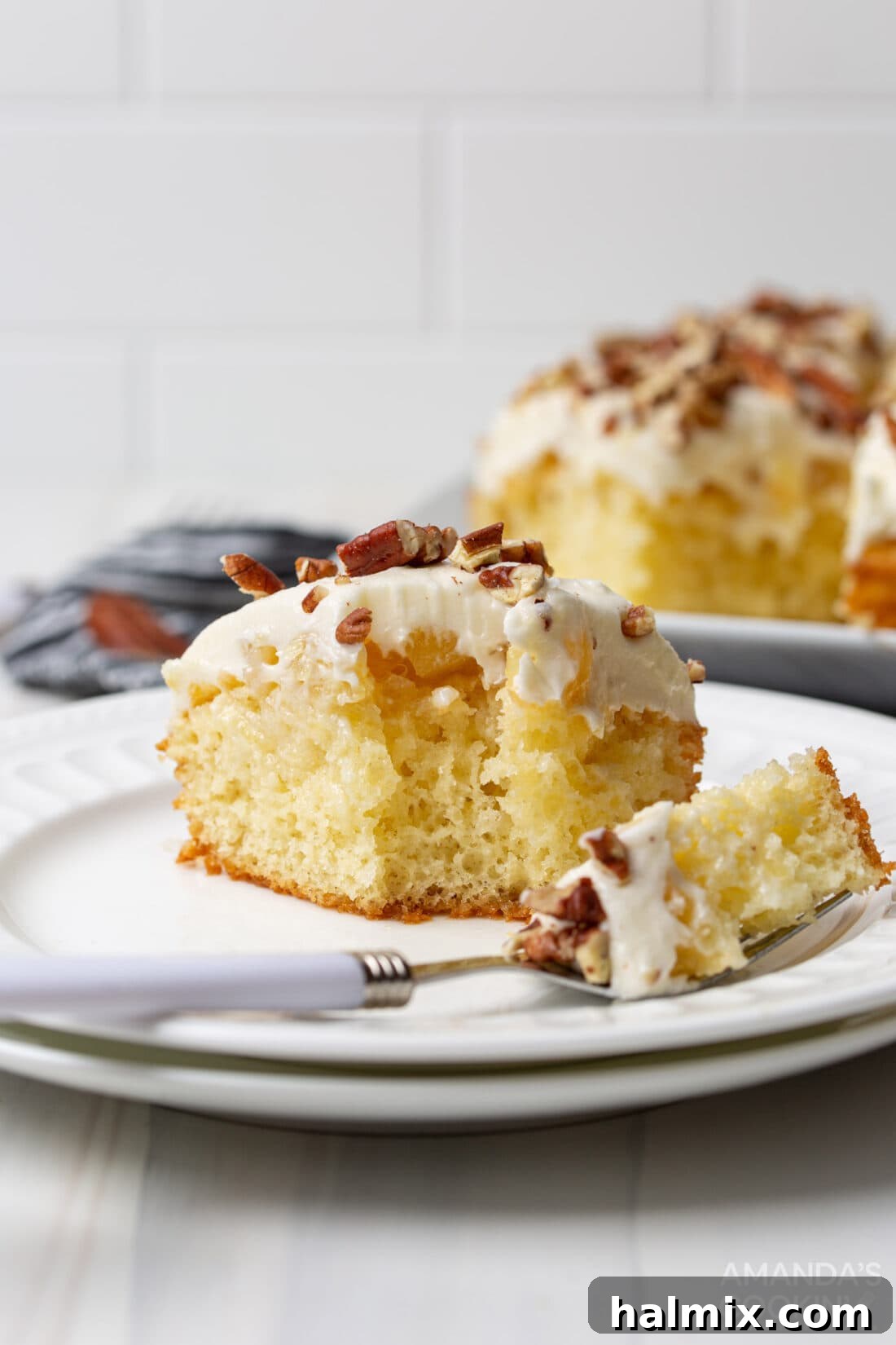 Elvis Presley Cake with a fork full removed, showing the moist interior infused with pineapple